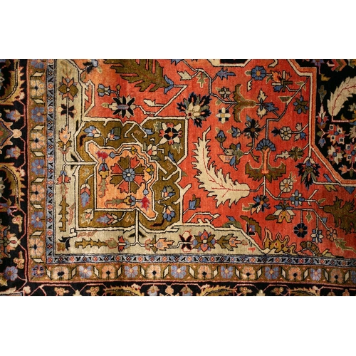 313 - An old brick red ground Heriz style silk on silk rug with central star lozenge with hanging lanterns... 