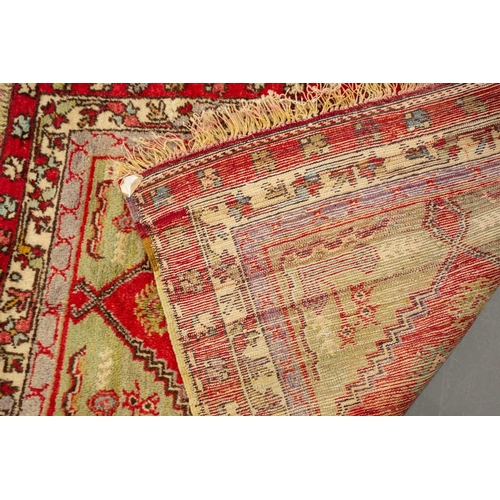 314 - A small North West Persian rd ground rug with stylized shrub decoration. 1.4 mtrs x 1 mtr, together ... 