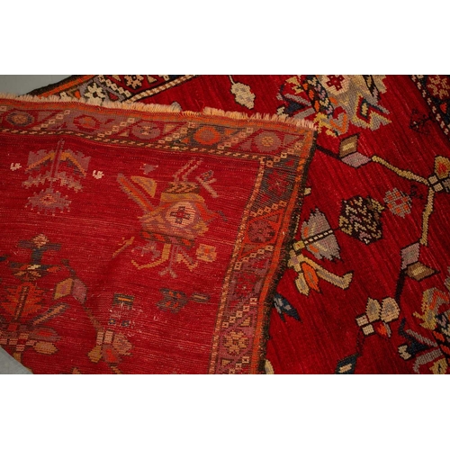 314 - A small North West Persian rd ground rug with stylized shrub decoration. 1.4 mtrs x 1 mtr, together ... 