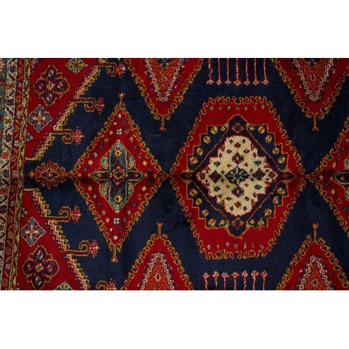 314 - A small North West Persian rd ground rug with stylized shrub decoration. 1.4 mtrs x 1 mtr, together ... 