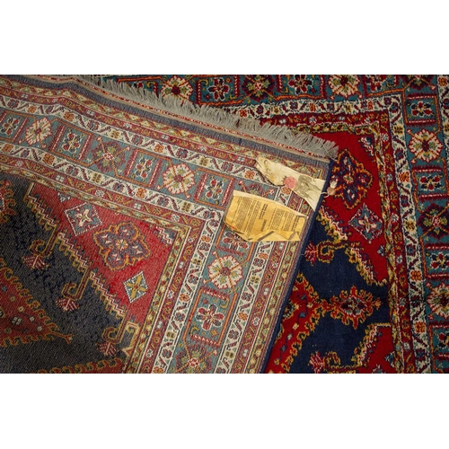 314 - A small North West Persian rd ground rug with stylized shrub decoration. 1.4 mtrs x 1 mtr, together ... 