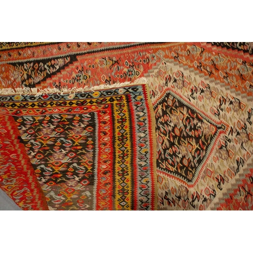 317 - A Turkish beige/pink ground Kelim with allover design 2.8 mtrs x 1.3 mtrs, and a Persian red ground ... 