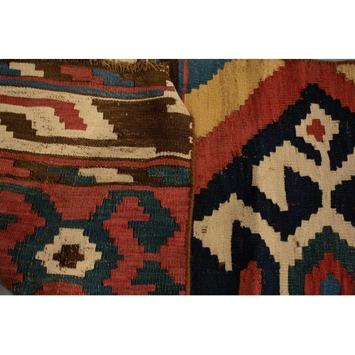 318 - A North African red ground kelim with banded decoration. within a zig-zag border, 1.6 mtrs x 1,1 mtr... 