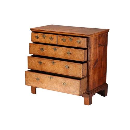 324 - A Queen Anne walnut and deal chest of two short over three long drawers, with a quarter veneered top... 