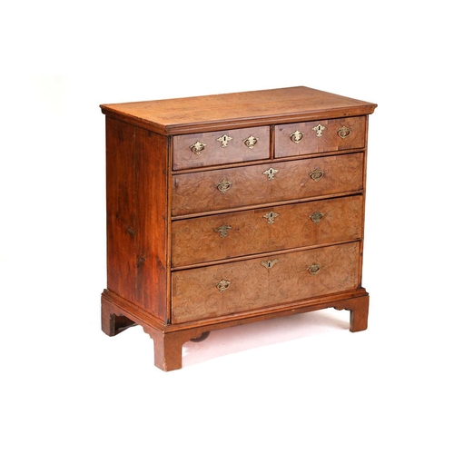 324 - A Queen Anne walnut and deal chest of two short over three long drawers, with a quarter veneered top... 