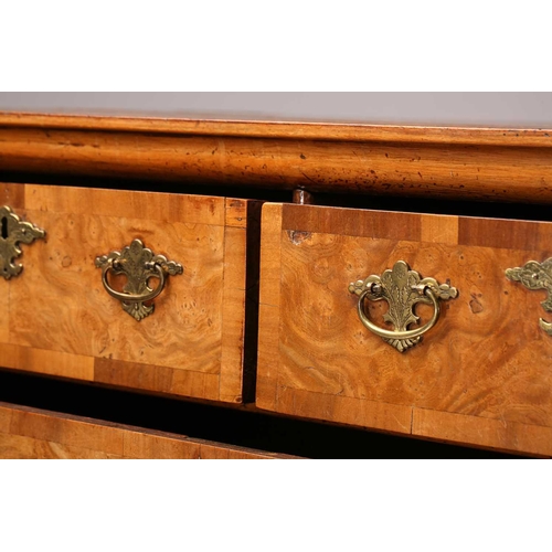 324 - A Queen Anne walnut and deal chest of two short over three long drawers, with a quarter veneered top... 