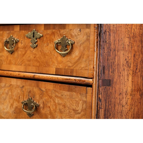 324 - A Queen Anne walnut and deal chest of two short over three long drawers, with a quarter veneered top... 