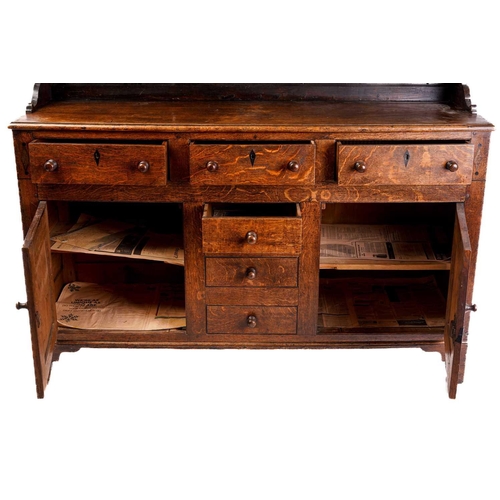 338 - An early 19th century Anglesey type oak and deal dresser base and rack, the rack with two shelves ab... 