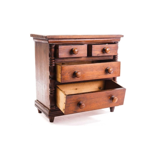 339 - A Victorian pitch pine miniature chest of drawers, fitted two short over two long drawers flanked by... 