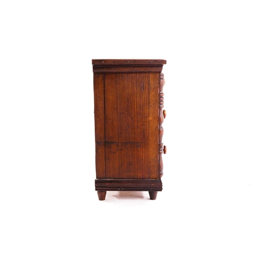 339 - A Victorian pitch pine miniature chest of drawers, fitted two short over two long drawers flanked by... 