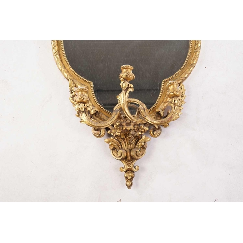 340 - A Victorian carved wood and gilt gesso lobed oval girandole with three scrolling candle sconces, 51 ... 