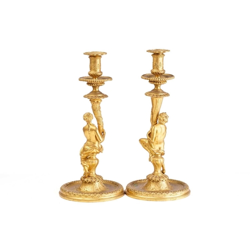 355 - In the manner of Corneille Van Cleve (1646-1732), a pair of French ormolu figural table candlesticks... 