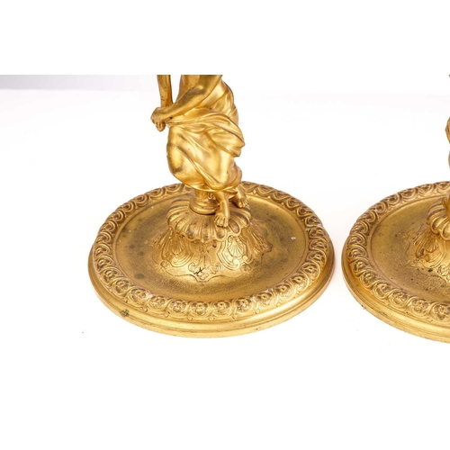 355 - In the manner of Corneille Van Cleve (1646-1732), a pair of French ormolu figural table candlesticks... 