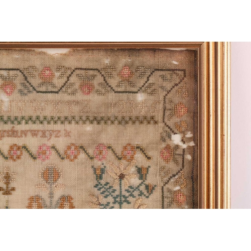 356 - A George III woolwork sampler, with the alphabet over a house surrounded by trees and pots of plants... 