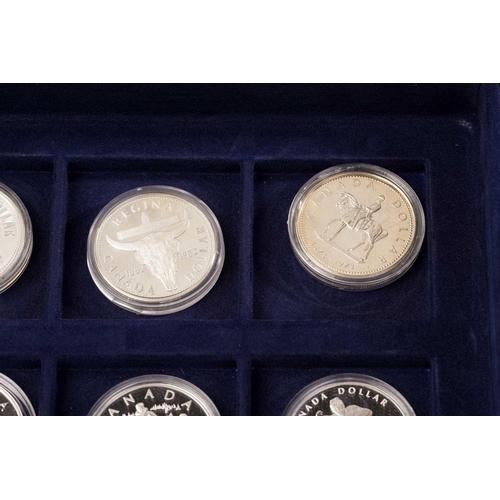 370 - The Official Coins of Australia and The Official Coins of the Royal Canadia Mint a group of twenty f... 