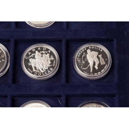 370 - The Official Coins of Australia and The Official Coins of the Royal Canadia Mint a group of twenty f... 