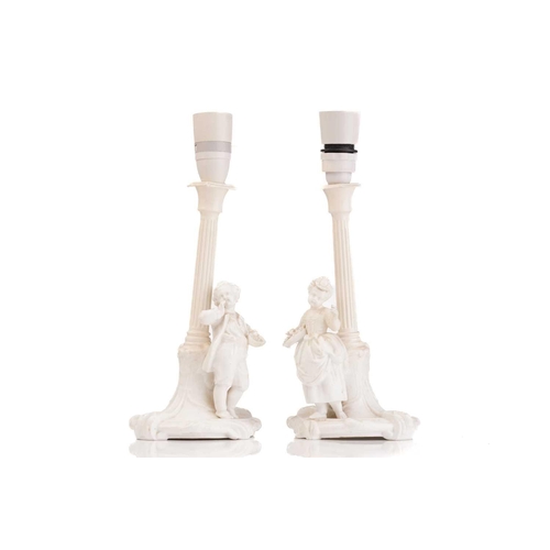 435 - A pair of Continental white glazed porcelain figural table lamps one with a young gentleman and one ... 