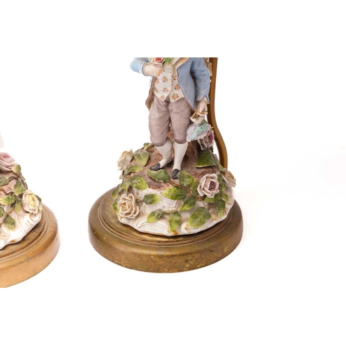 439 - A pair of late 19th-century Continental porcelain figural table lamps ,one mounted with a young gall... 