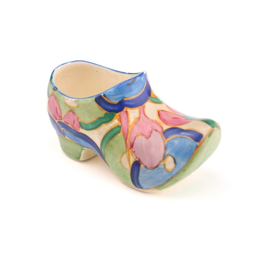 444 - A Clarice Cliff Fantasque design clog in a blue floral design, (with chip), 11 cm long, and a Claric... 