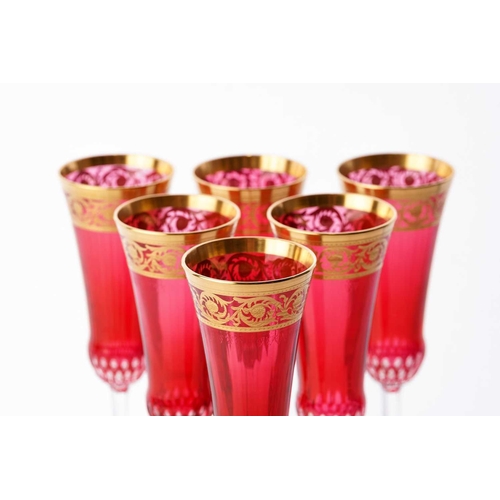 455 - A set of six Saint-Louis red crystal glass thistle design champagne flutes, with original box and wr... 