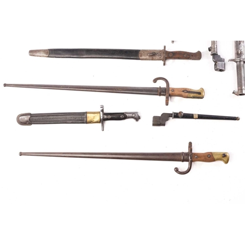 482 - A collection of nine bayonets to include two French Usine De Steyr sword bayonets and scabbards a Ge... 