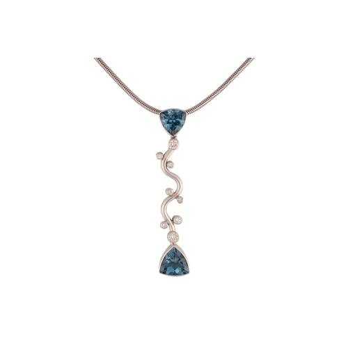 103 - A topaz and diamond pendant on chain, the elongated vertical pendant comprises a wavy mount, intersp... 