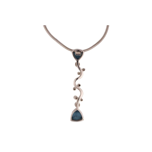 103 - A topaz and diamond pendant on chain, the elongated vertical pendant comprises a wavy mount, intersp... 