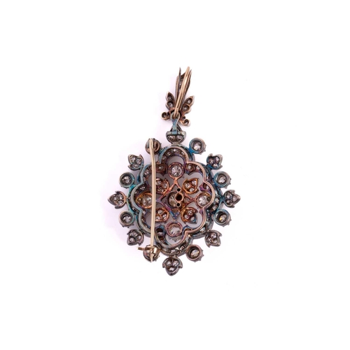 11 - A Victorian floral pendant brooch set with old-cut diamonds, the lozenge-shaped design scintillating... 