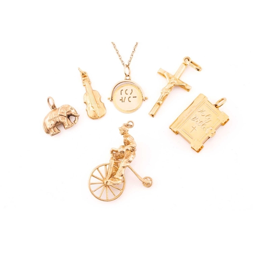 110 - A miscellaneous aggregate of 9ct yellow gold items; including a charm in the form of a gentleman rid... 