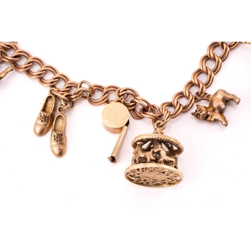 113 - A 9ct gold charm bracelet with nine assorted charms, consisting of a double curb link chain, suspend... 