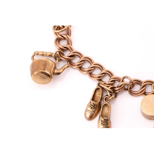 113 - A 9ct gold charm bracelet with nine assorted charms, consisting of a double curb link chain, suspend... 