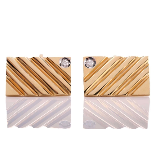 118 - A pair of cufflinks with diamond accents, each comprising a diagonally striated rectangular panel, s... 