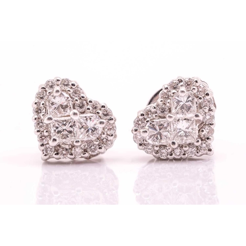 127 - A pair of heart-shaped diamond ear studs, each set with three princess cut diamonds, approximately 0... 