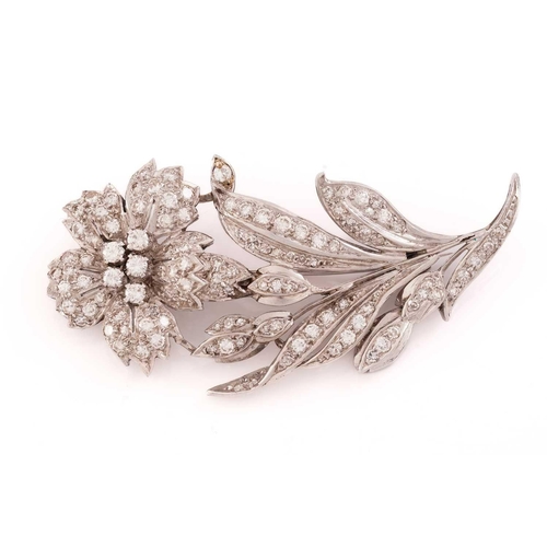 13 - A flower brooch set with diamonds, the realistically modeled spray scintillating with circular-cut d... 