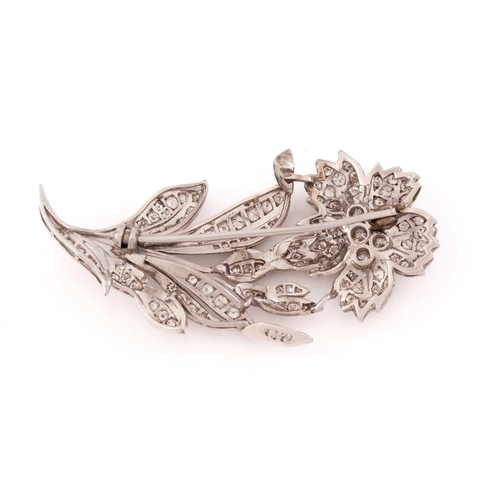 13 - A flower brooch set with diamonds, the realistically modeled spray scintillating with circular-cut d... 