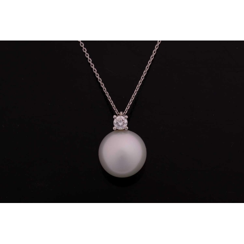 133 - A south sea pearl necklace, featuring a round white silver south sea pearl of 13.6 mm, attached to a... 