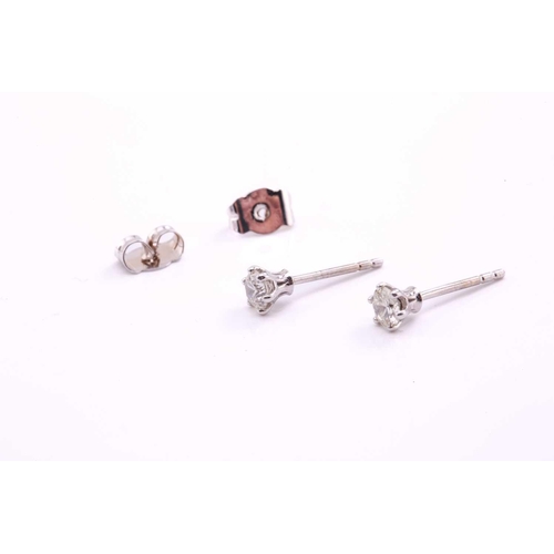 134 - A pair of diamond stud earrings in 18ct white gold, each featuring a round brilliant diamond in a cl... 