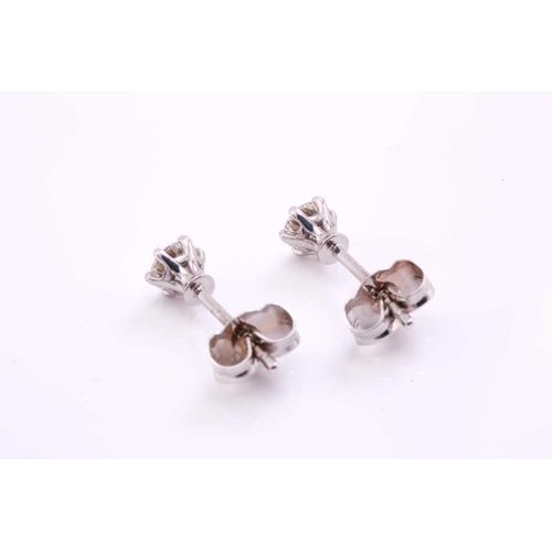 134 - A pair of diamond stud earrings in 18ct white gold, each featuring a round brilliant diamond in a cl... 