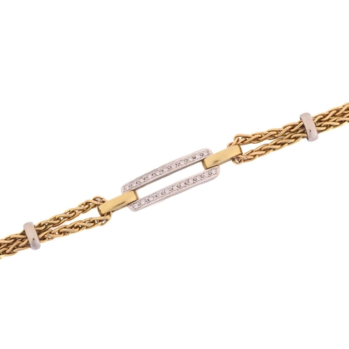 140 - A two-tone bracelet set with diamonds, containing an elongated double bar pavé set with circular-cut... 