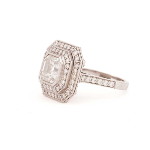 141 - An Art Deco style diamond ring, the central Asscher cut diamond within a two-row surround of round b... 