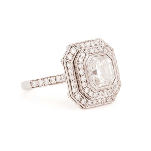 141 - An Art Deco style diamond ring, the central Asscher cut diamond within a two-row surround of round b... 