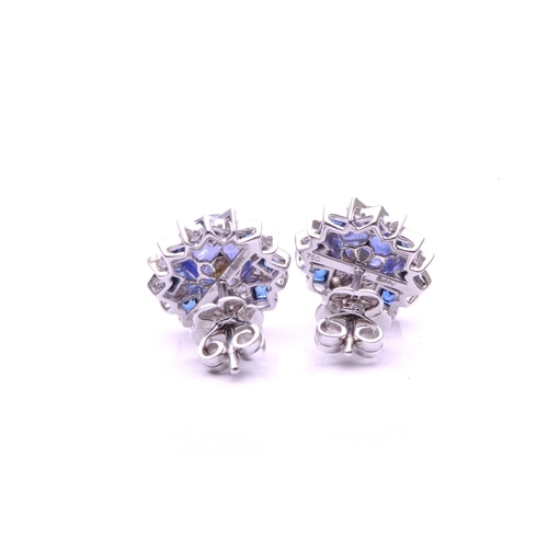 143 - A pair of sapphire, diamond and cabochon tanzanite cluster earrings; of overlapping star design with... 