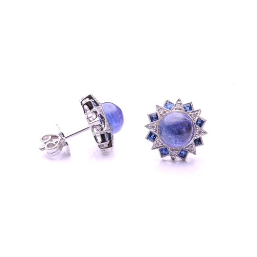 143 - A pair of sapphire, diamond and cabochon tanzanite cluster earrings; of overlapping star design with... 