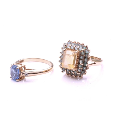 144 - A pale sapphire ring; the oval cut sapphire in four claw mount, the tapering shoulders set with sing... 