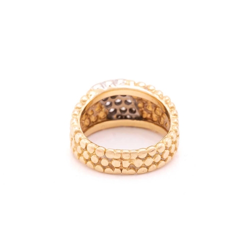 150 - A dress ring with a stripe of 15 pave set diamonds on a textured bead band measuring 10mm tapering d... 