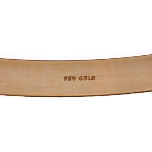 154 - A yellow metal closed bangle, with a solid D-profile band, marked as '750 OBLO', internal circumfere... 