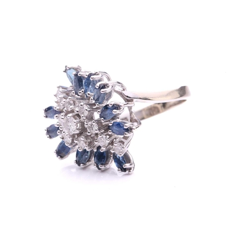 155A - A sapphire and diamond cluster ring, the navette-shaped cluster comprises circular-cut diamonds and ... 