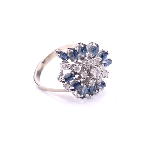 155A - A sapphire and diamond cluster ring, the navette-shaped cluster comprises circular-cut diamonds and ... 