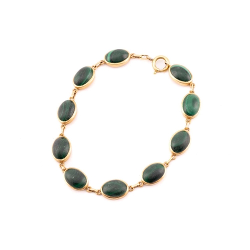 159 - A malachite pendant and bracelet, the pendant comprises a navette-shaped malachite cabochon set in c... 