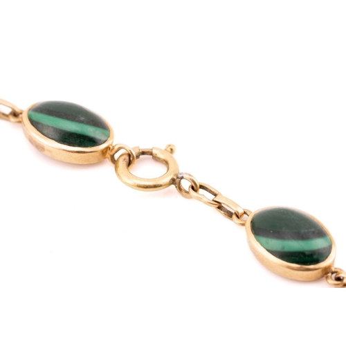 159 - A malachite pendant and bracelet, the pendant comprises a navette-shaped malachite cabochon set in c... 